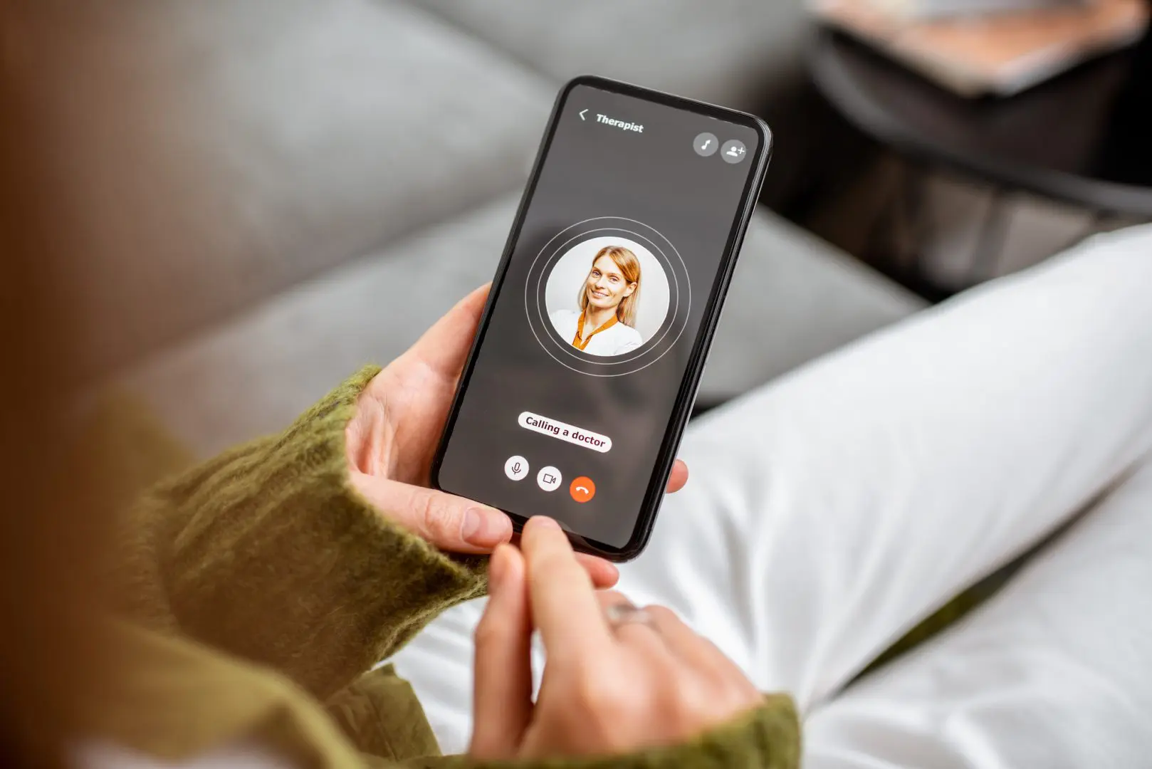 woman speaking with therapist on smart phone