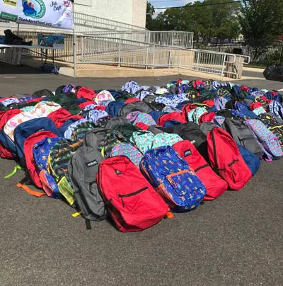backpacks in parking lot for tools for schools