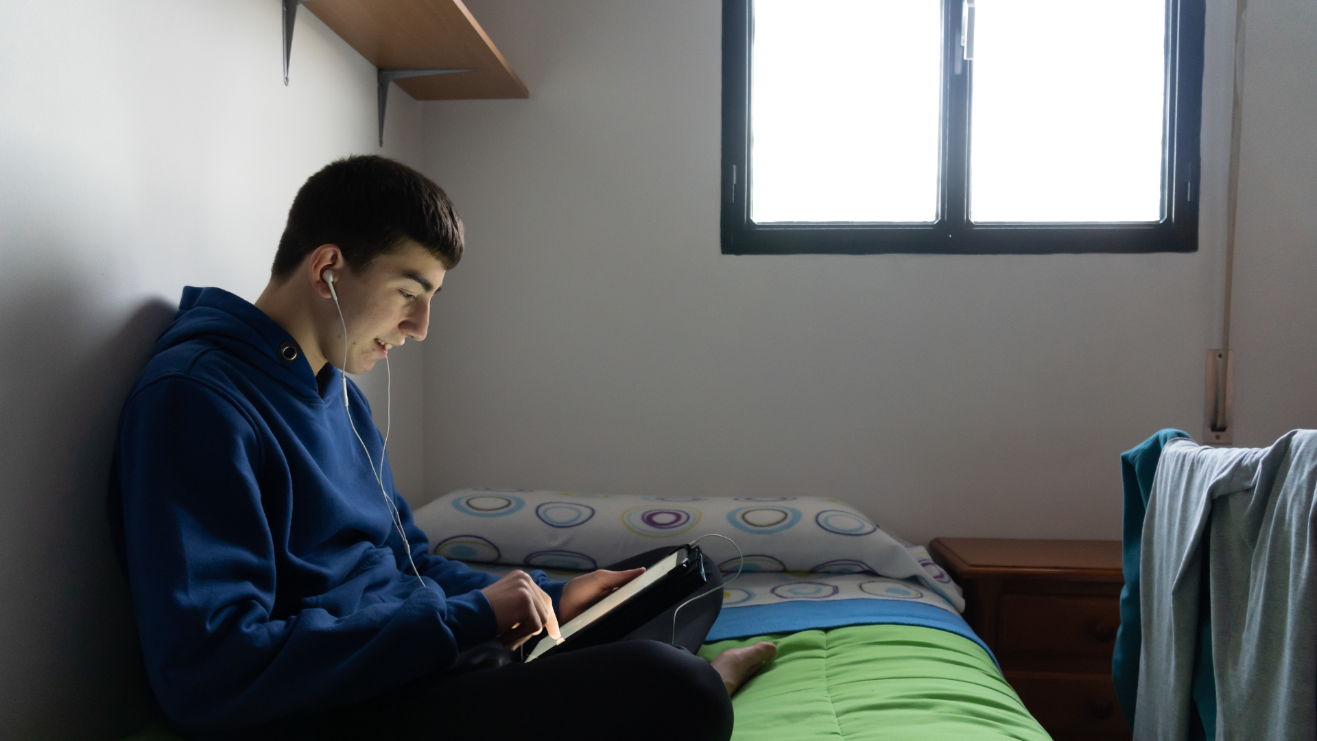 Untitled design (52) child sitting in his room alone