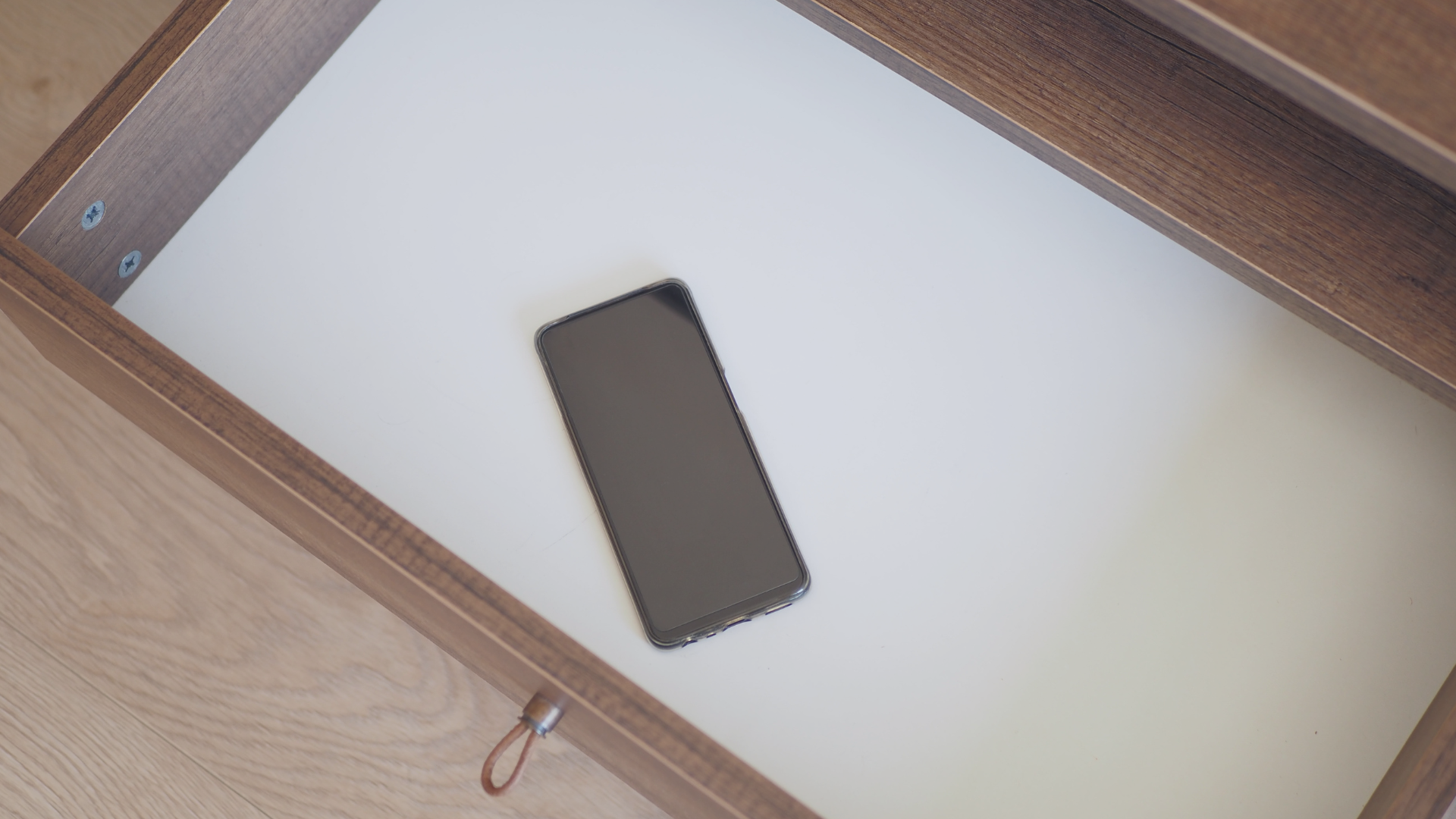 Untitled design (3) A smartphone lies in a drawer, one way to detach yourself from the media during election season.