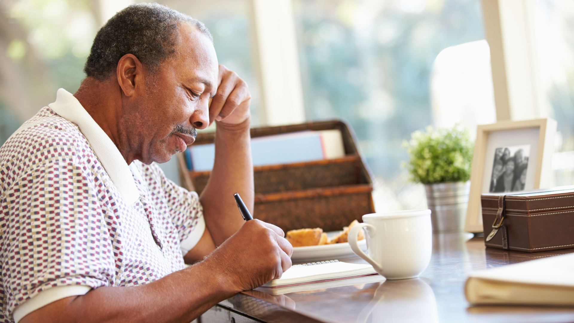 A man sets aside time so he can practice self-care by writing. 