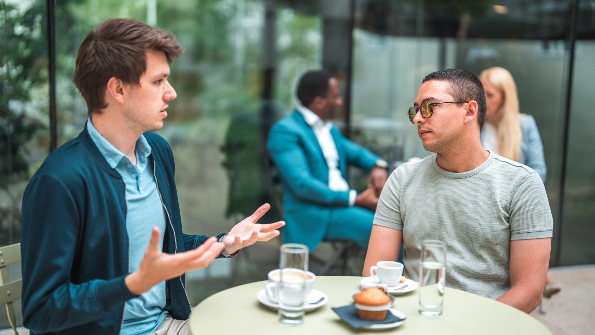 Two male friends reconnect over coffee. This is one way to better your mental health and support yourself and others.