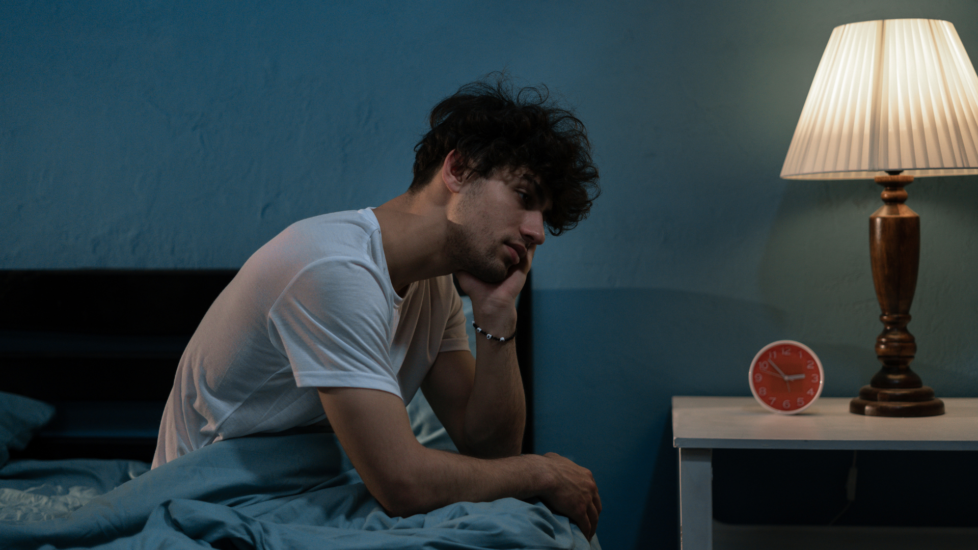 Man is suffering from Seasonal Affective Disorder in bed. 