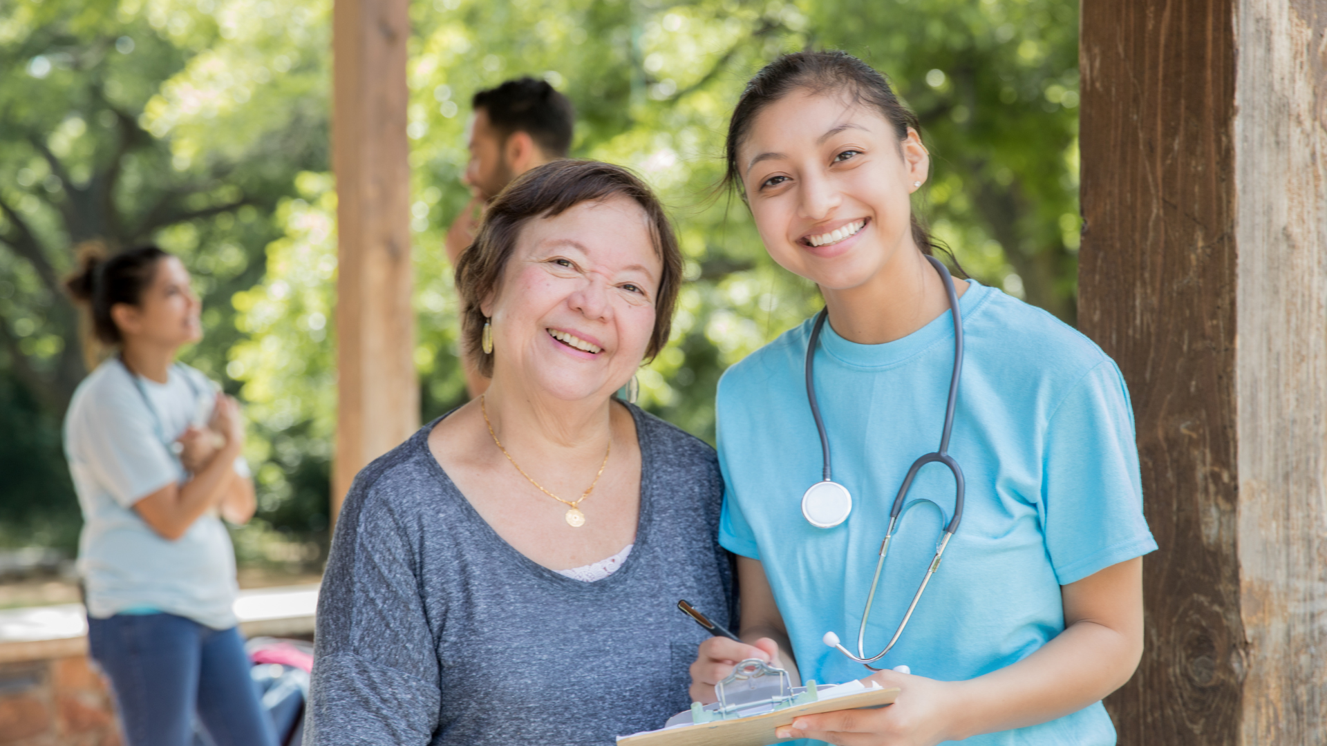 Untitled design (53) A nurse helps her coworker during a wellness fair, held by their work during Stress Awareness Month.