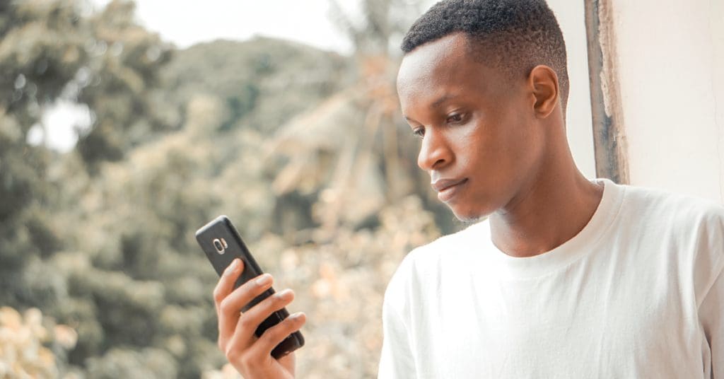 teenager staring at cell phone screen