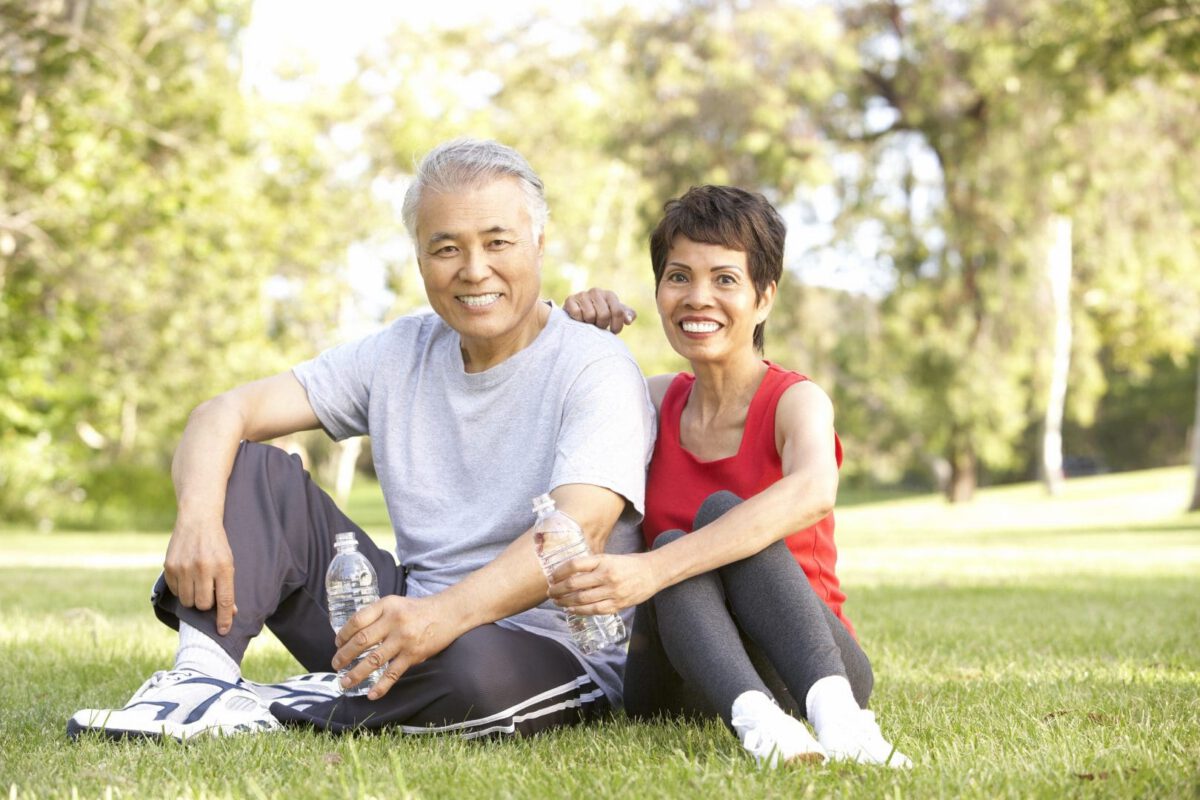 older couple resting at park after exercising