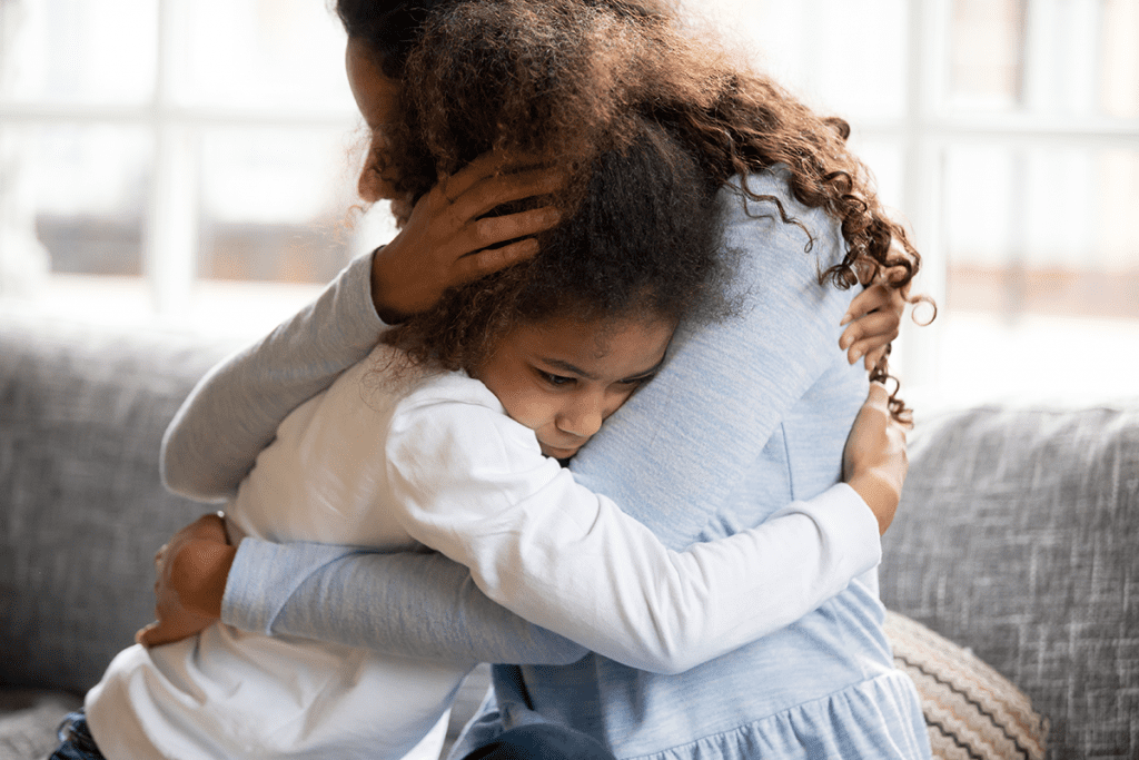 mother and daughter hugging and grieving from loss