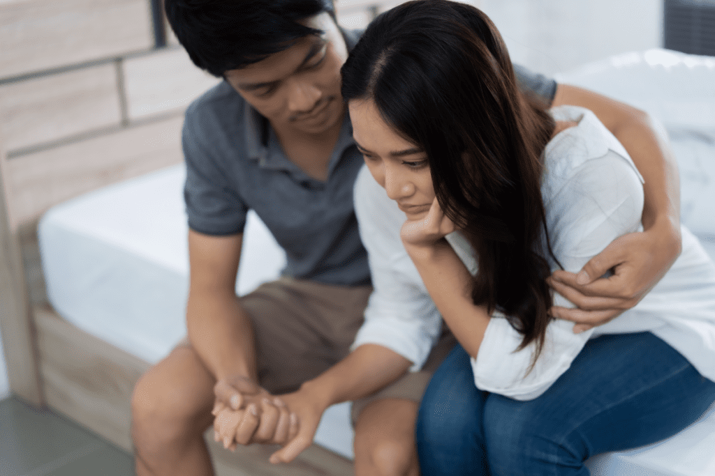 man comforting upset woman