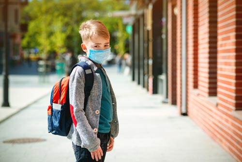 little boy back to school wearing mask