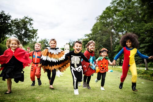 children running with halloween costumes