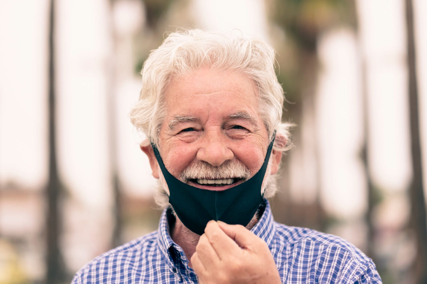 older man taking off mask when will life return to normal