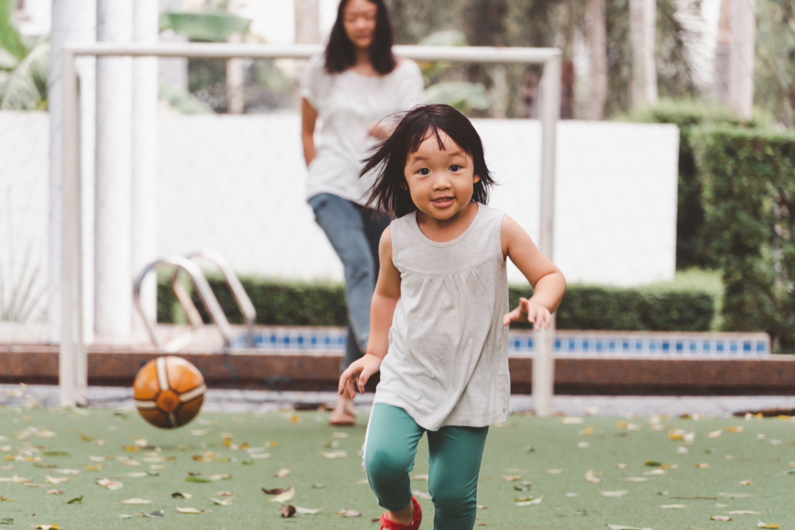 child development young asian girl playing soccer