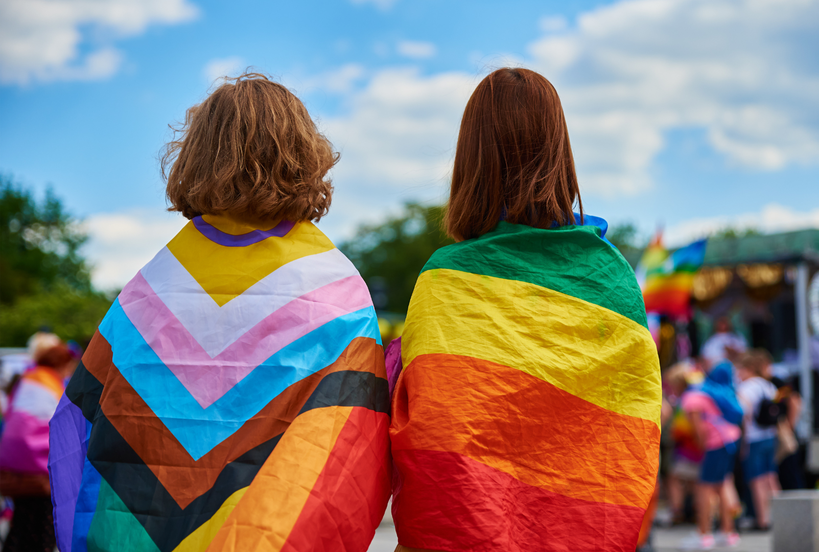 two young people wearing lgbtq+ flags, LGBTQ+ mental health