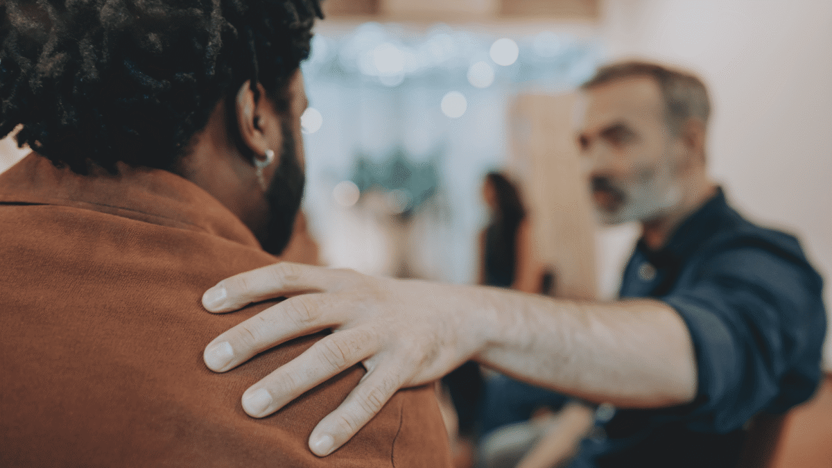 Peer support specialist comforting a client in treatment.