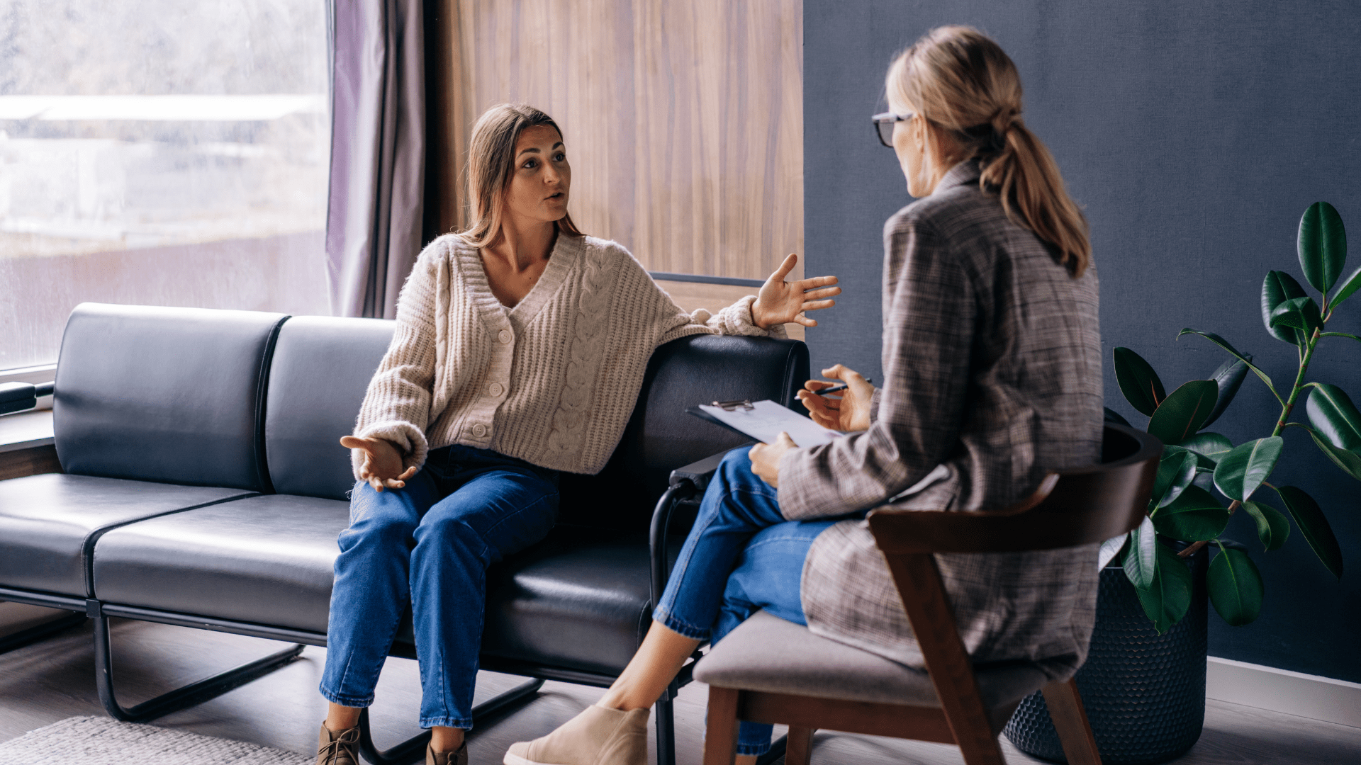 A woman seeks therapy services from a mental health professional.