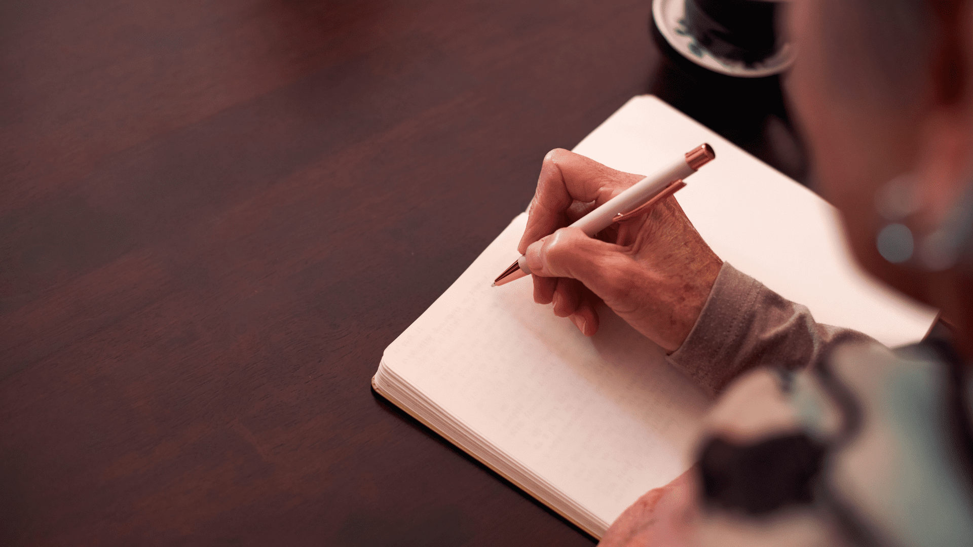 Person writing a letter of encouragement to their family member in residential treatment.