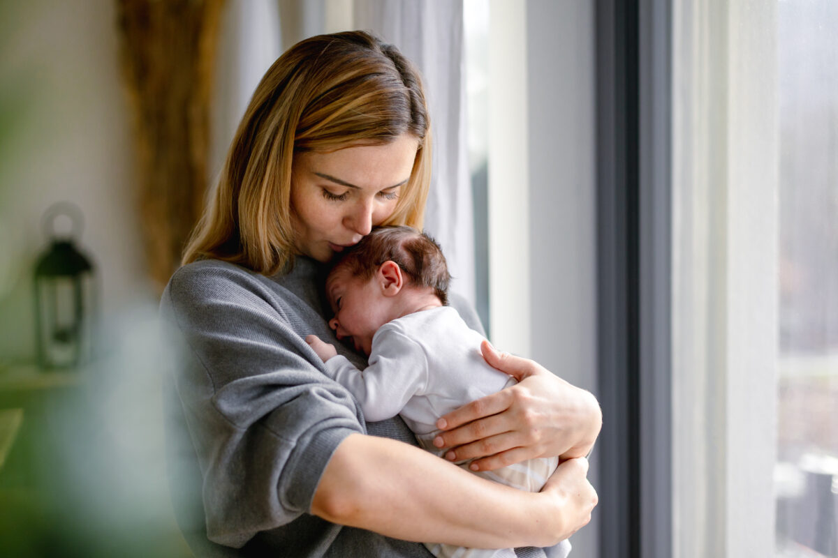 New mother holds her newborn baby.